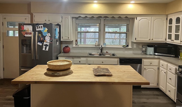 190 E Poplar St, Piggott, AR 72454 - kitchen featuring dark wood finished floors, white cabinets, appliances with stainless steel finishes, and a sink