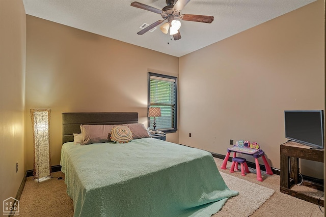 carpeted bedroom with visible vents, a ceiling fan, and baseboards