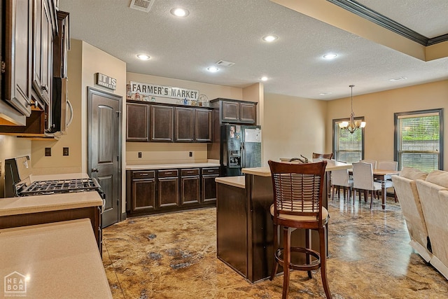 kitchen with dark brown cabinetry, light countertops, a textured ceiling, and black refrigerator with ice dispenser