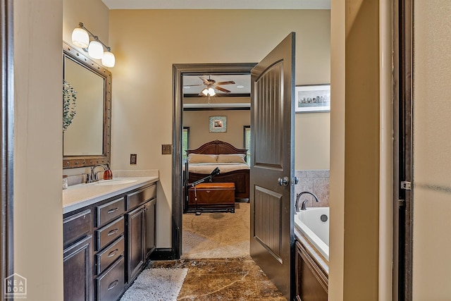 ensuite bathroom with connected bathroom, vanity, and a bath