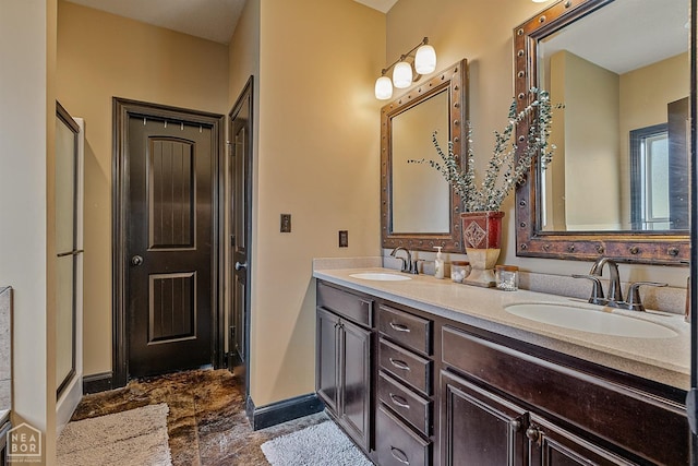 bathroom featuring double vanity, a sink, marble finish floor, and baseboards