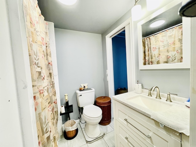 bathroom with vanity, toilet, a shower with shower curtain, and tile patterned flooring