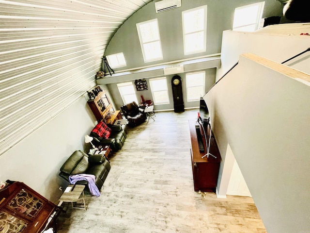 interior space featuring wood finished floors and high vaulted ceiling