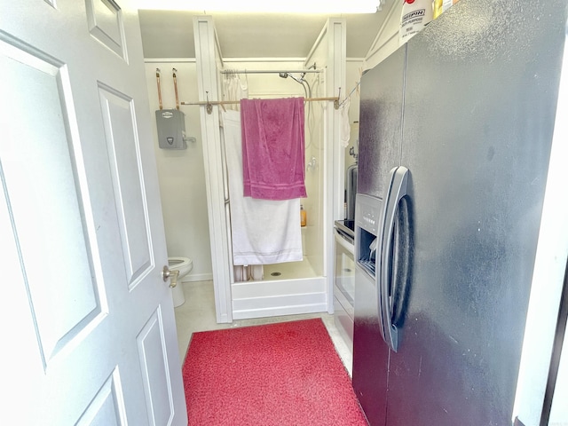 full bathroom featuring toilet and a stall shower