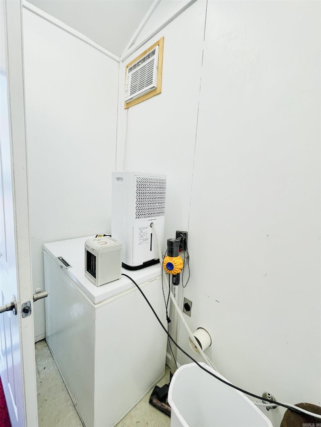 laundry room featuring an AC wall unit and laundry area