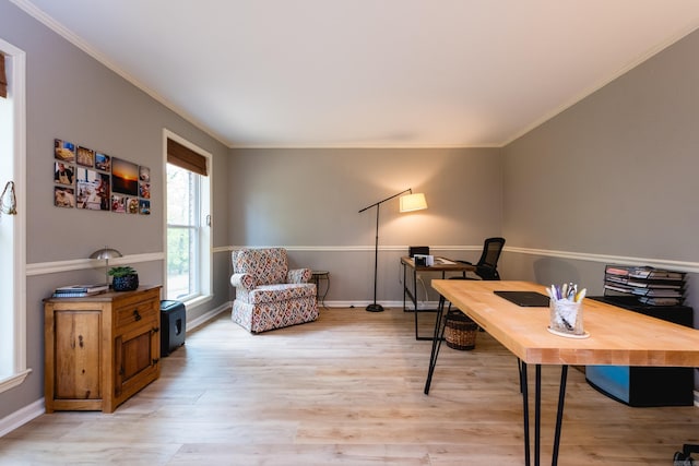 office area featuring crown molding, baseboards, and light wood-style floors