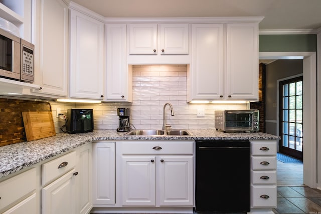 kitchen featuring a sink, dishwasher, white cabinets, and decorative backsplash