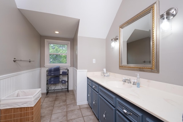 bathroom with lofted ceiling, vanity, and tile patterned floors