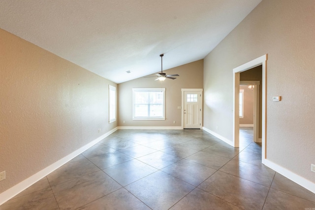 unfurnished room featuring a ceiling fan, lofted ceiling, and a textured wall