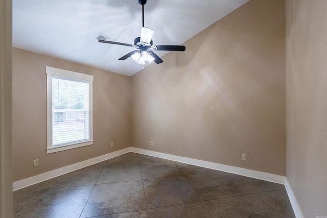 spare room featuring baseboards, a ceiling fan, and vaulted ceiling
