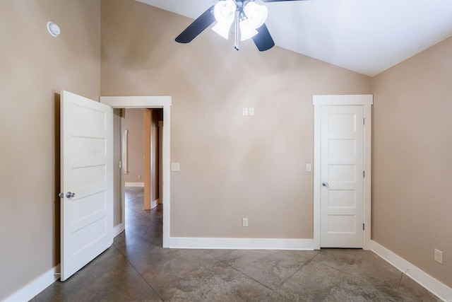 empty room featuring baseboards, a ceiling fan, concrete flooring, and vaulted ceiling