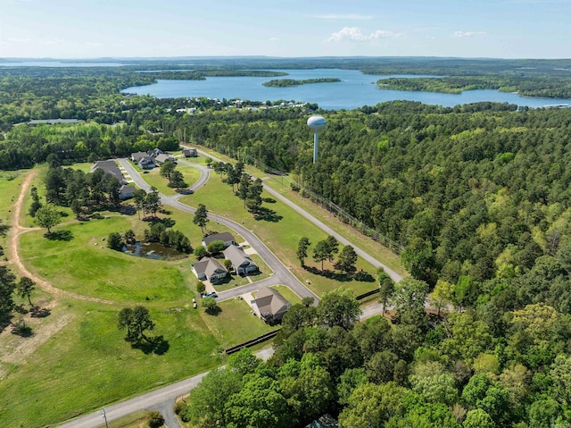 drone / aerial view featuring a water view and a forest view