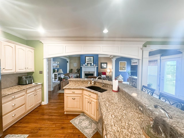 7 Samantha Cir, Searcy, AR 72143 - kitchen featuring a sink, ornamental molding, dark wood finished floors, decorative columns, and a fireplace