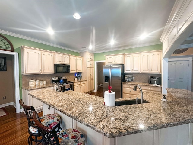7 Samantha Cir, Searcy, AR 72143 - kitchen with stainless steel appliances, a kitchen breakfast bar, backsplash, baseboards, and dark wood finished floors