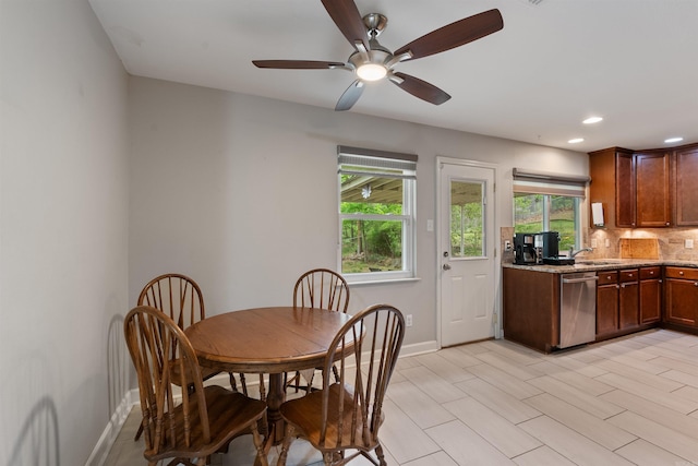 dining room featuring baseboards, recessed lighting, a ceiling fan, and plenty of natural light