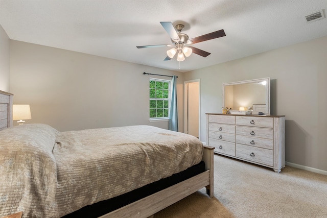 bedroom featuring visible vents, ceiling fan, carpet floors, and baseboards