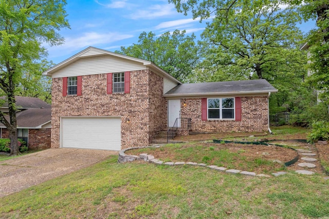 split level home with driveway, a front yard, an attached garage, and brick siding
