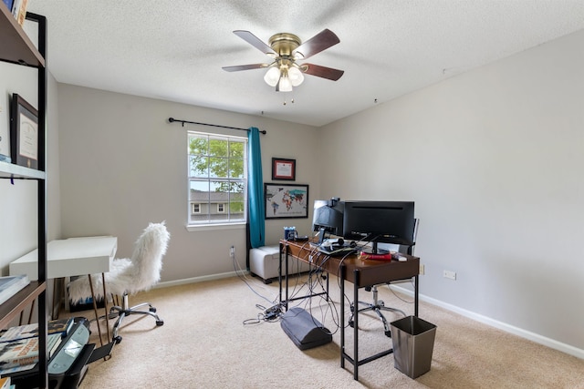carpeted office with baseboards, ceiling fan, and a textured ceiling