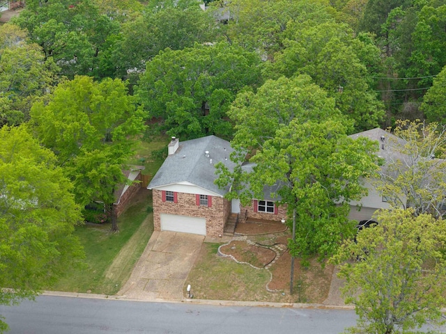 birds eye view of property with a forest view