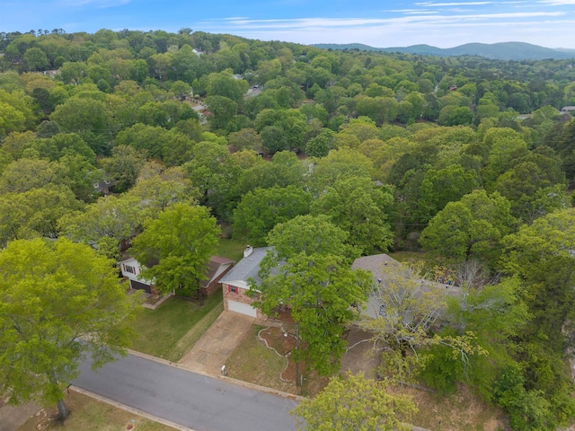 drone / aerial view with a mountain view and a forest view