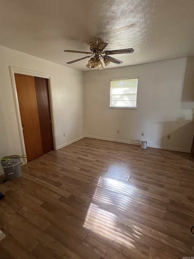 904 Belmont Dr, Pine Bluff, AR 71601 - unfurnished bedroom with wood finished floors, a ceiling fan, and baseboards
