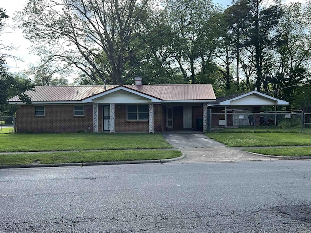 904 Belmont Dr, Pine Bluff, AR 71601 - ranch-style home with fence, metal roof, a carport, driveway, and a front lawn
