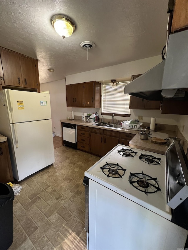 904 Belmont Dr, Pine Bluff, AR 71601 - kitchen featuring white appliances, light countertops, a sink, visible vents, and a textured ceiling