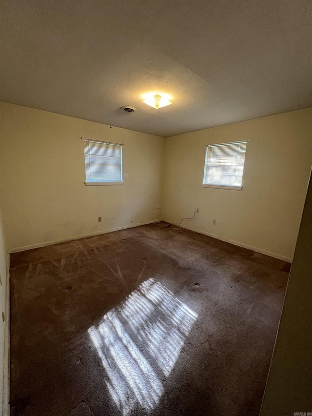 904 Belmont Dr, Pine Bluff, AR 71601 - spare room featuring baseboards, a wealth of natural light, and carpet floors
