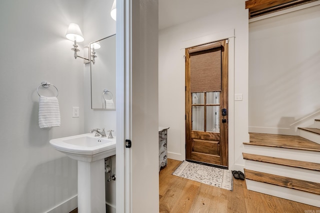bathroom featuring wood finished floors and baseboards