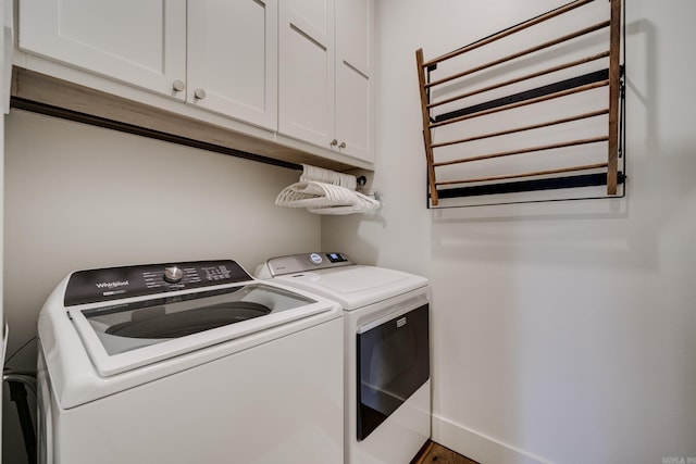 washroom with radiator heating unit, cabinet space, and washing machine and dryer