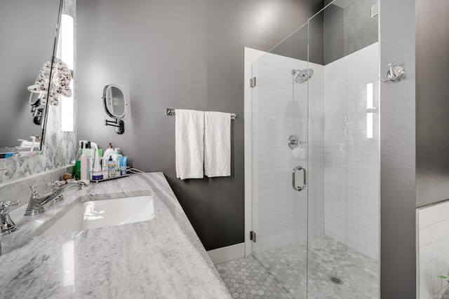 full bathroom with a shower stall and vanity