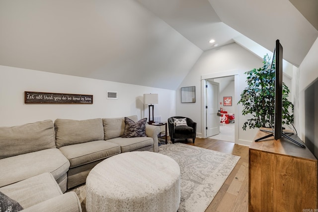 living area with lofted ceiling, visible vents, baseboards, recessed lighting, and wood finished floors
