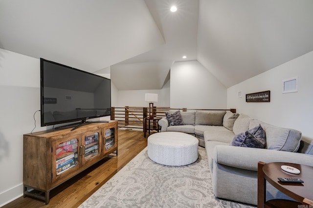 living room with visible vents, wood finished floors, recessed lighting, and vaulted ceiling