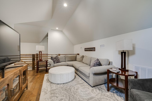 living room featuring visible vents, lofted ceiling, light wood finished floors, and recessed lighting