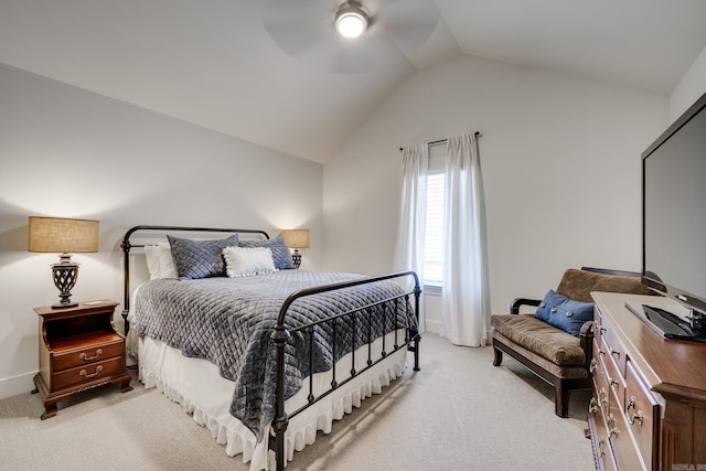 bedroom featuring lofted ceiling, a ceiling fan, baseboards, and light carpet