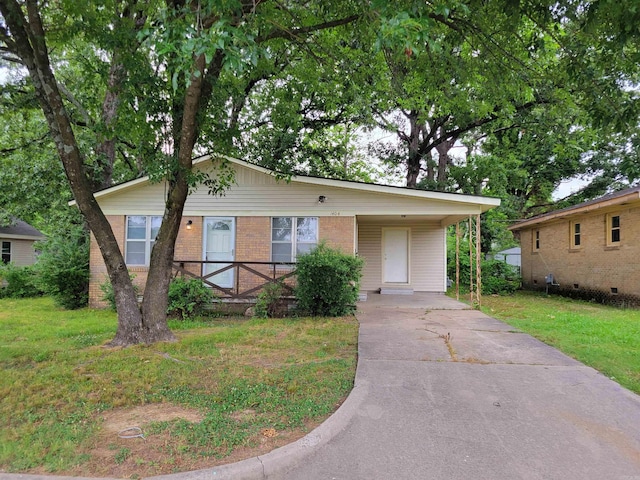 single story home featuring a front yard, driveway, an attached carport, and brick siding