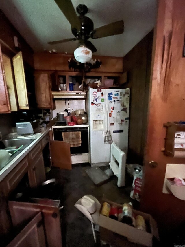 kitchen with range with electric cooktop, white fridge with ice dispenser, under cabinet range hood, a ceiling fan, and brown cabinetry