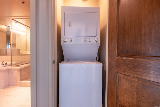 laundry area with stacked washer and dryer and laundry area