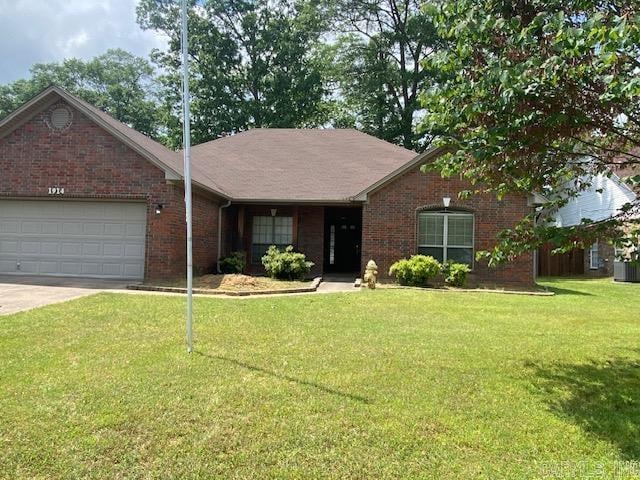 ranch-style home featuring a front lawn, a garage, concrete driveway, and brick siding