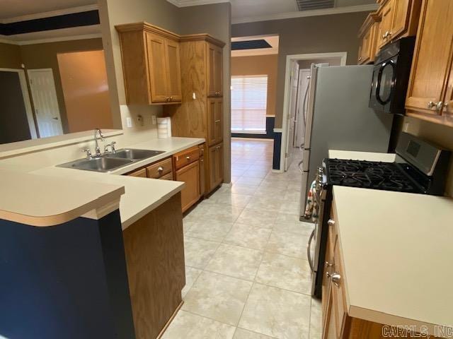 kitchen with a sink, brown cabinets, stainless steel range with gas cooktop, crown molding, and black microwave