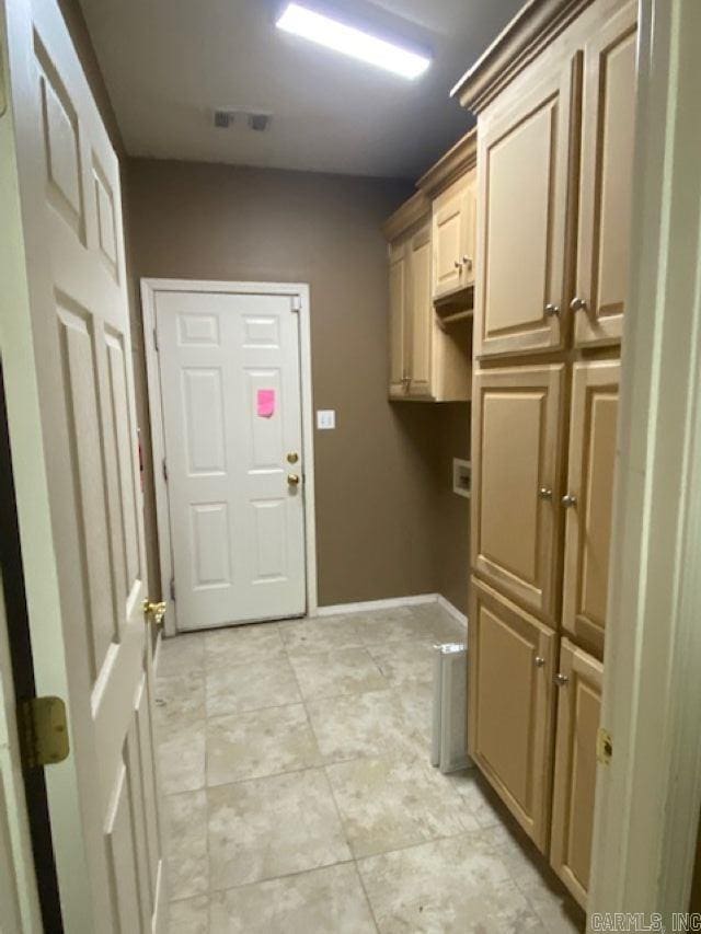 clothes washing area featuring baseboards, visible vents, and laundry area