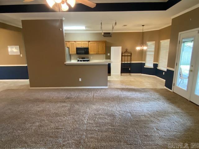 kitchen featuring black microwave, ceiling fan, light brown cabinets, and crown molding