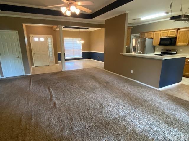 kitchen with stainless steel appliances, ceiling fan, ornamental molding, and light colored carpet