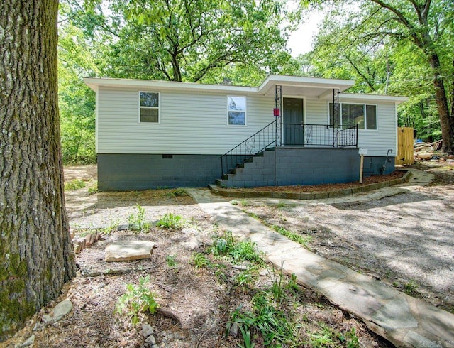 view of front of property featuring crawl space, a porch, and stairs