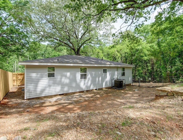 back of house featuring central AC and a fenced backyard