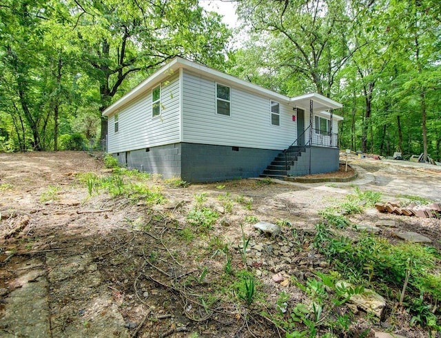 manufactured / mobile home featuring covered porch, stairway, and crawl space