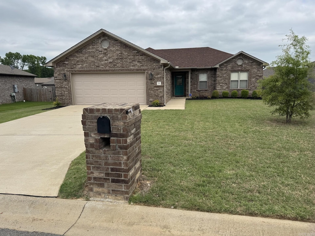 ranch-style home featuring concrete driveway, a front lawn, a garage, and brick siding