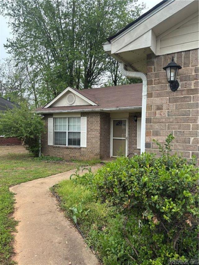 entrance to property featuring brick siding