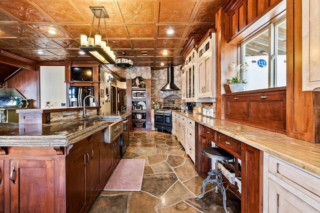 kitchen featuring glass insert cabinets, double oven range, stainless steel microwave, a sink, and an ornate ceiling