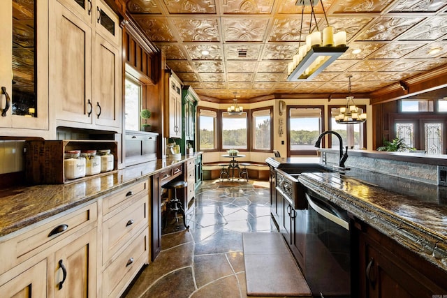 kitchen with stone tile floors, a wealth of natural light, stainless steel dishwasher, and a sink